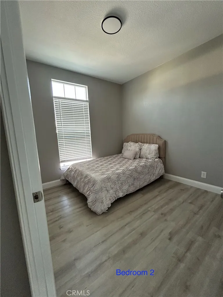 10550 Western, Unit 32 Stanton, CA 90680 - Photo 18 of 31 a bedroom with a bed and wooden floor