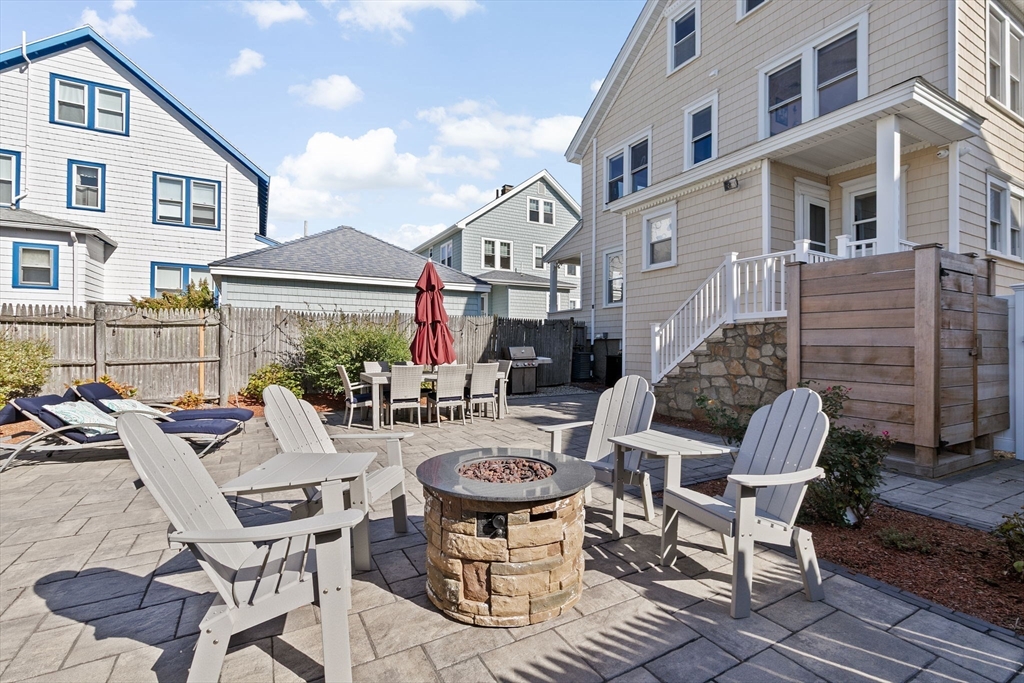 79 F Street Hull, MA 02045 - Photo 8 of 42 a view of a patio with a dining table and chairs with wooden floor and a yard