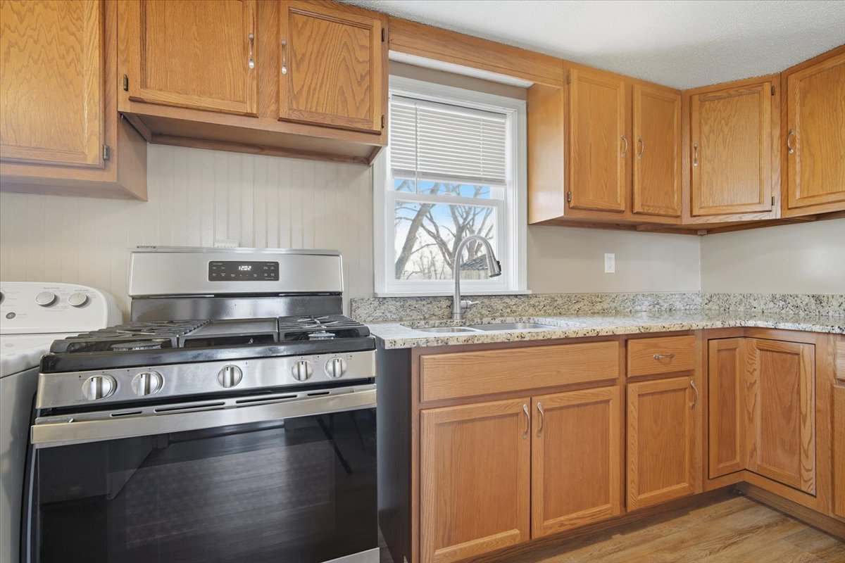 118 Florida Avenue Washington, IL 61571 - Photo 12 of 23 a kitchen with granite countertop white cabinets and a stove