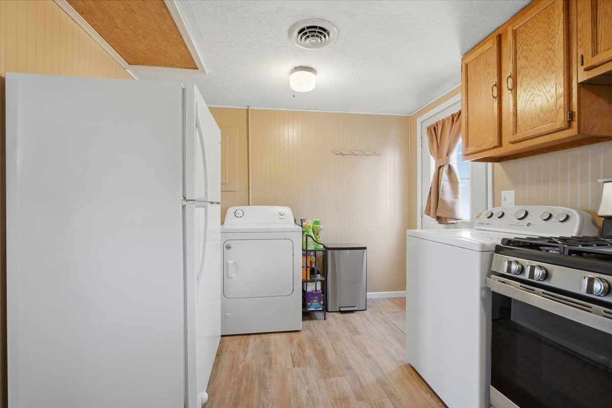118 Florida Avenue Washington, IL 61571 - Photo 13 of 23 a view of a kitchen with fridge and wooden floor