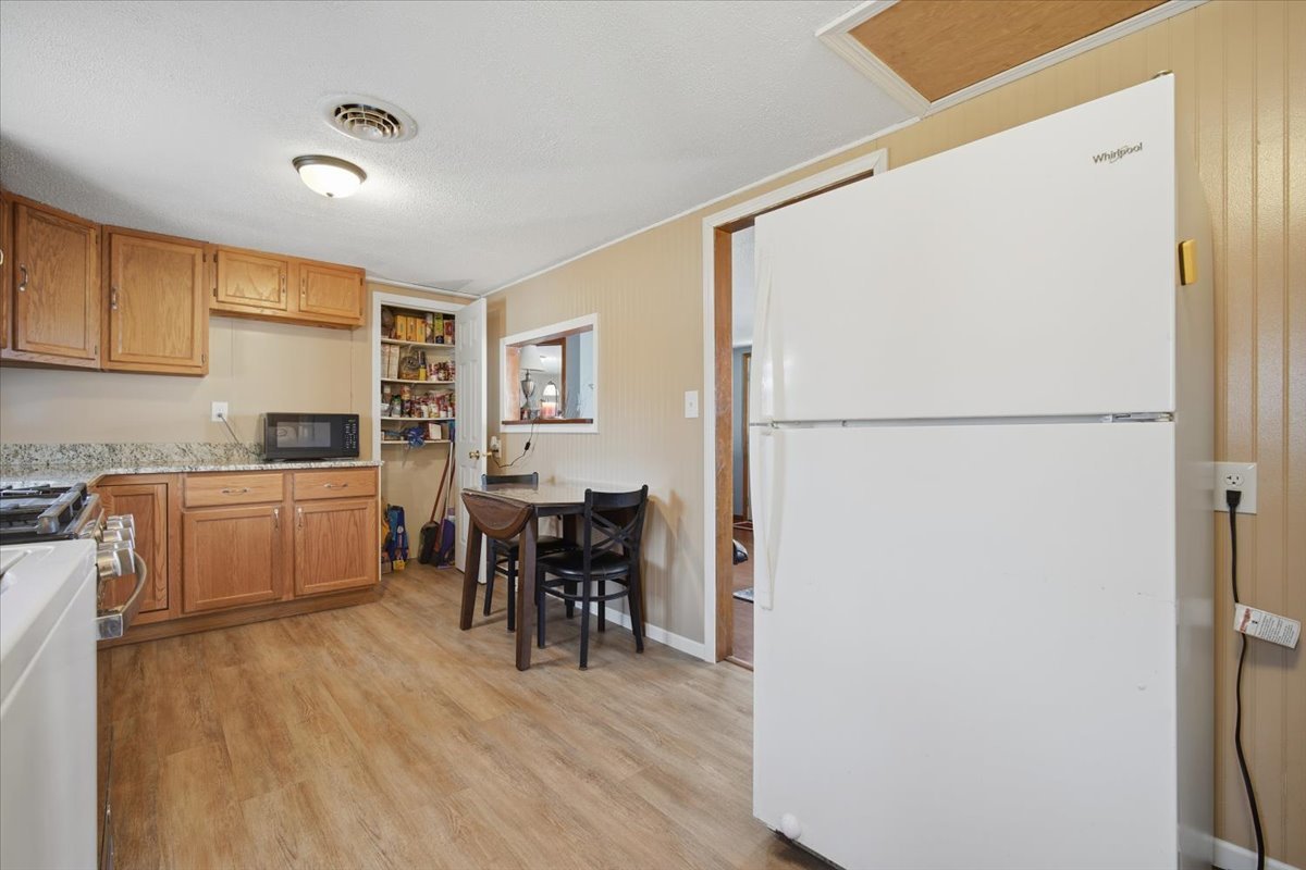 118 Florida Avenue Washington, IL 61571 - Photo 15 of 23 a kitchen with a refrigerator a table and chairs