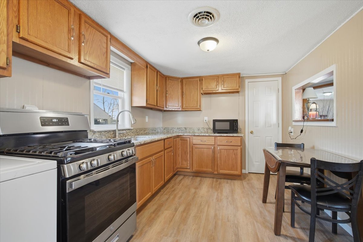 118 Florida Avenue Washington, IL 61571 - Photo 9 of 23 a kitchen with a stove a sink and a refrigerator