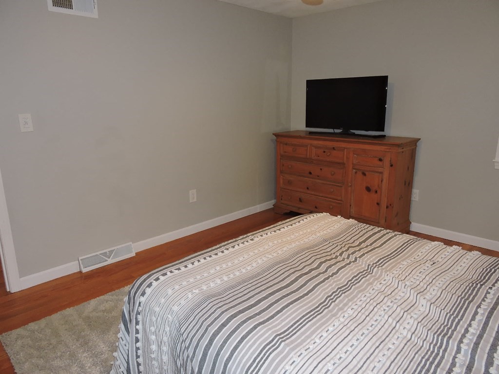 46 Lexington Road Billerica, MA 01821 - Photo 16 of 41 a bedroom with a bed and a flat screen tv