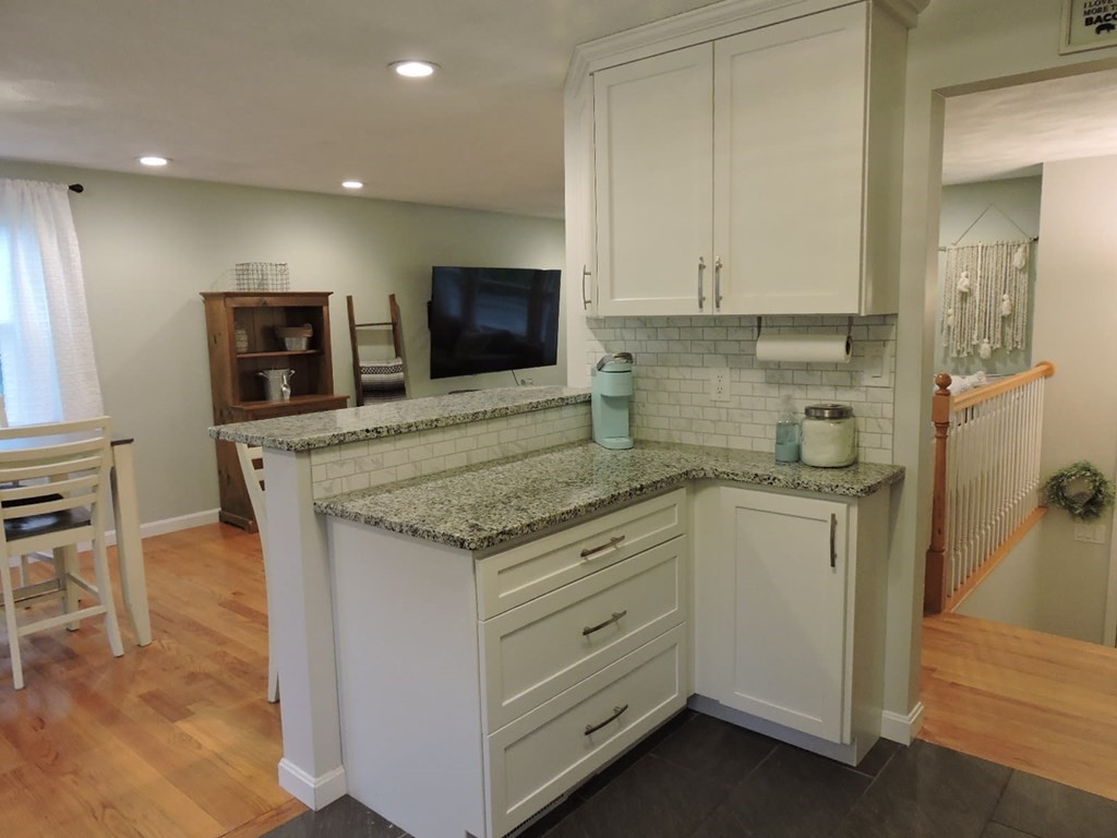46 Lexington Road Billerica, MA 01821 - Photo 9 of 41 a kitchen with granite countertop cabinets stainless steel appliances and a counter space
