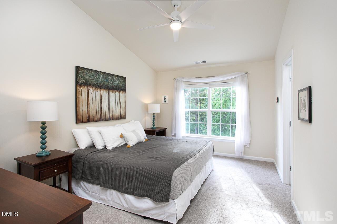 1662 Snow Mass Way Durham, NC 27713 - Photo 13 of 24 a spacious bedroom with a large bed and a window