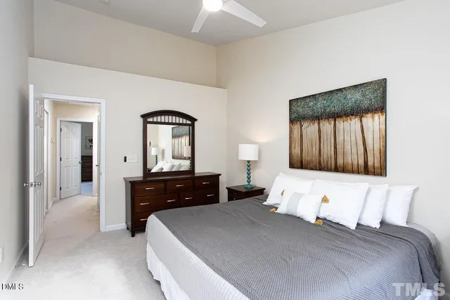 a bedroom with a bed and a dresser with mirror