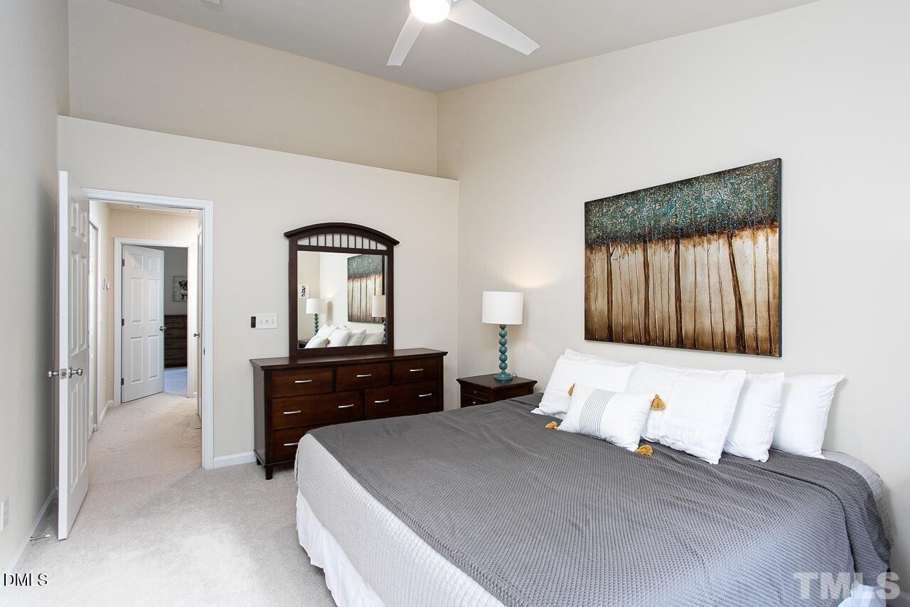 1662 Snow Mass Way Durham, NC 27713 - Photo 14 of 24 a bedroom with a bed and a dresser with mirror