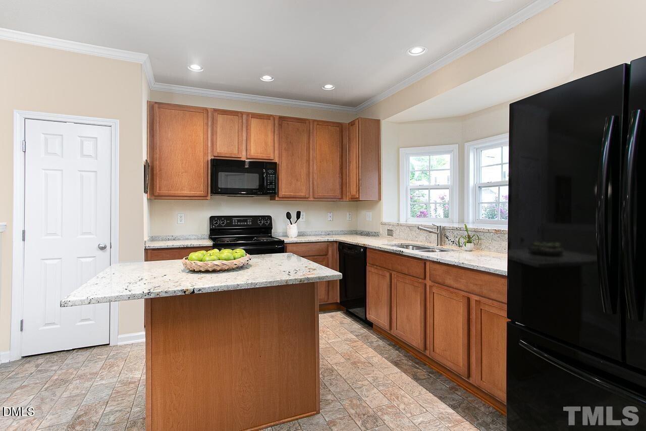 1662 Snow Mass Way Durham, NC 27713 - Photo 4 of 24 a kitchen with a stove a sink and a refrigerator