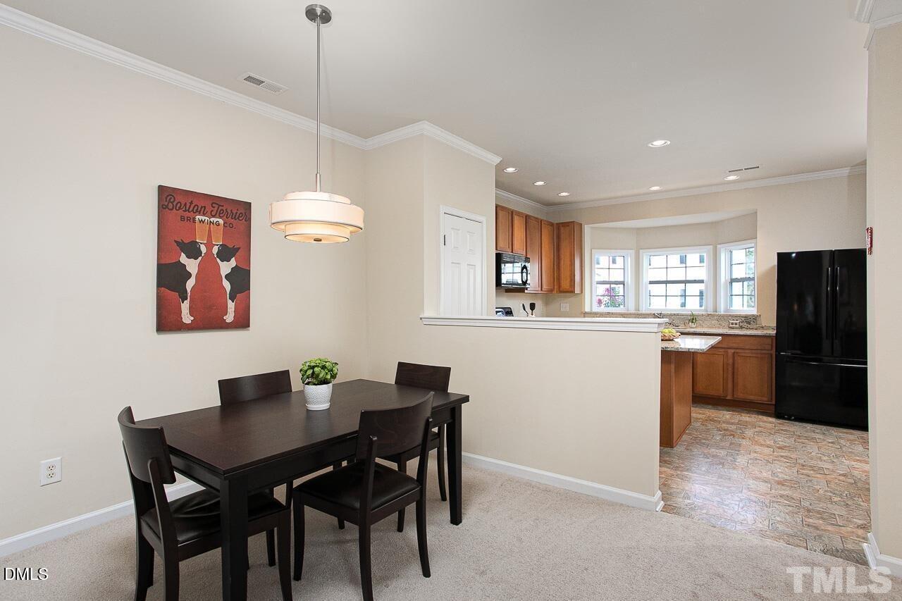 1662 Snow Mass Way Durham, NC 27713 - Photo 7 of 24 a dining room with a table chairs and kitchen view