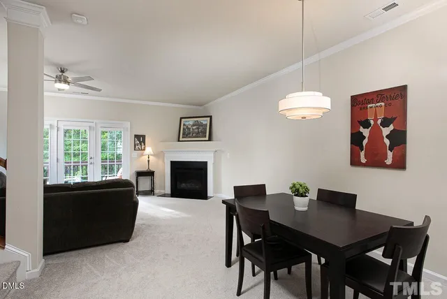a living room with furniture a table and a fireplace