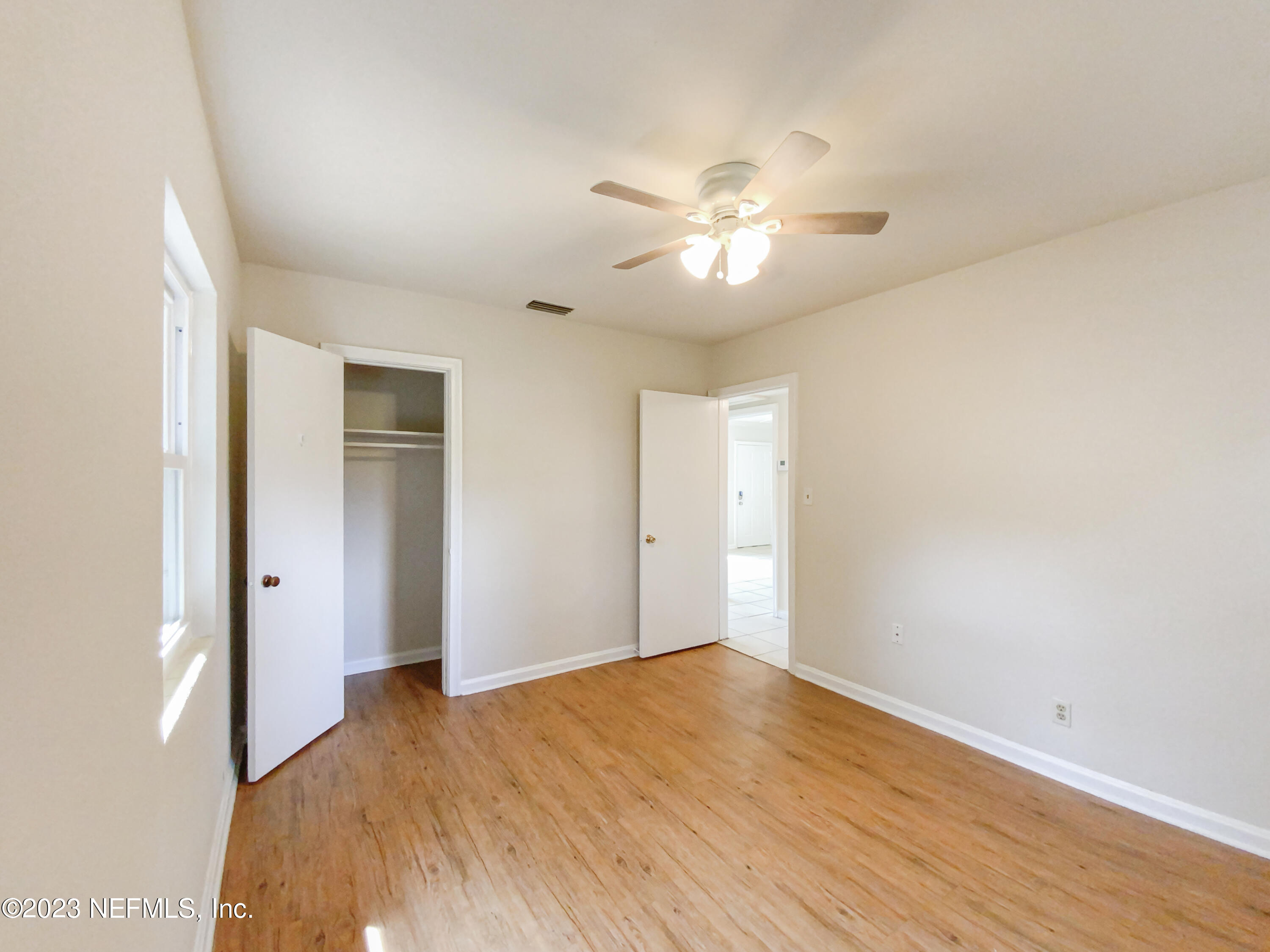 6231 Commodore Drive Jacksonville, FL 32244 - Photo 15 of 18 a view of empty room with wooden floor