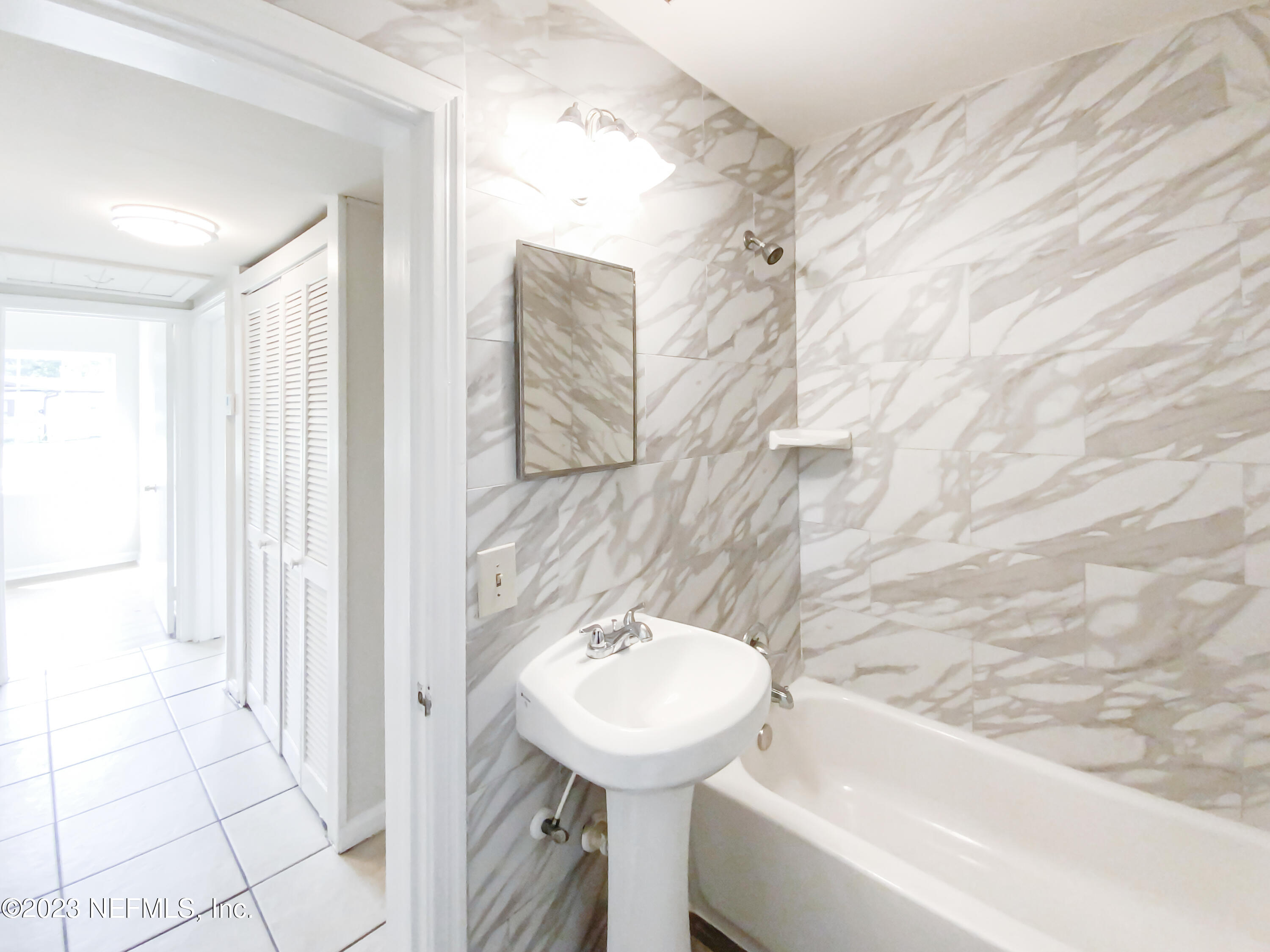 6231 Commodore Drive Jacksonville, FL 32244 - Photo 17 of 18 a bathroom with a sink a toilet and bathtub