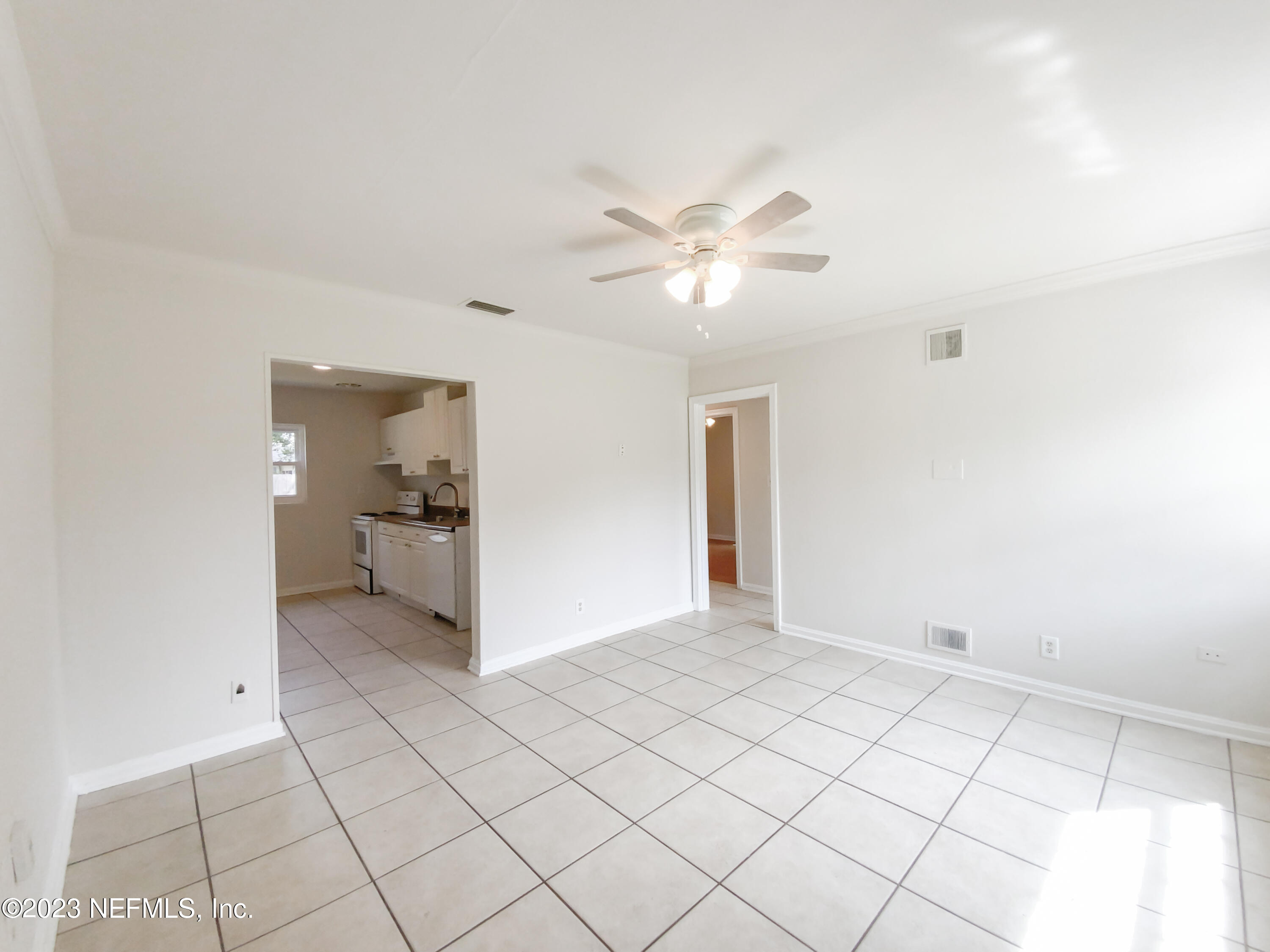 6231 Commodore Drive Jacksonville, FL 32244 - Photo 8 of 18 a view of a livingroom with a chandelier fan and windows