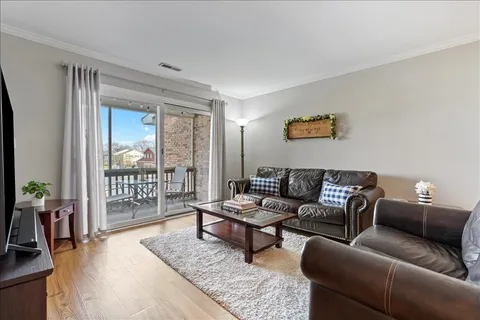 a living room with furniture and a floor to ceiling window