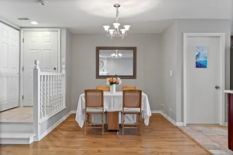a view of a dining room with furniture wooden floor and chandelier