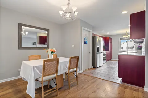 a view of a dining room with furniture wooden floor and chandelier