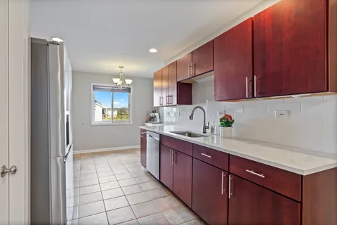 a kitchen with a sink a refrigerator and cabinets