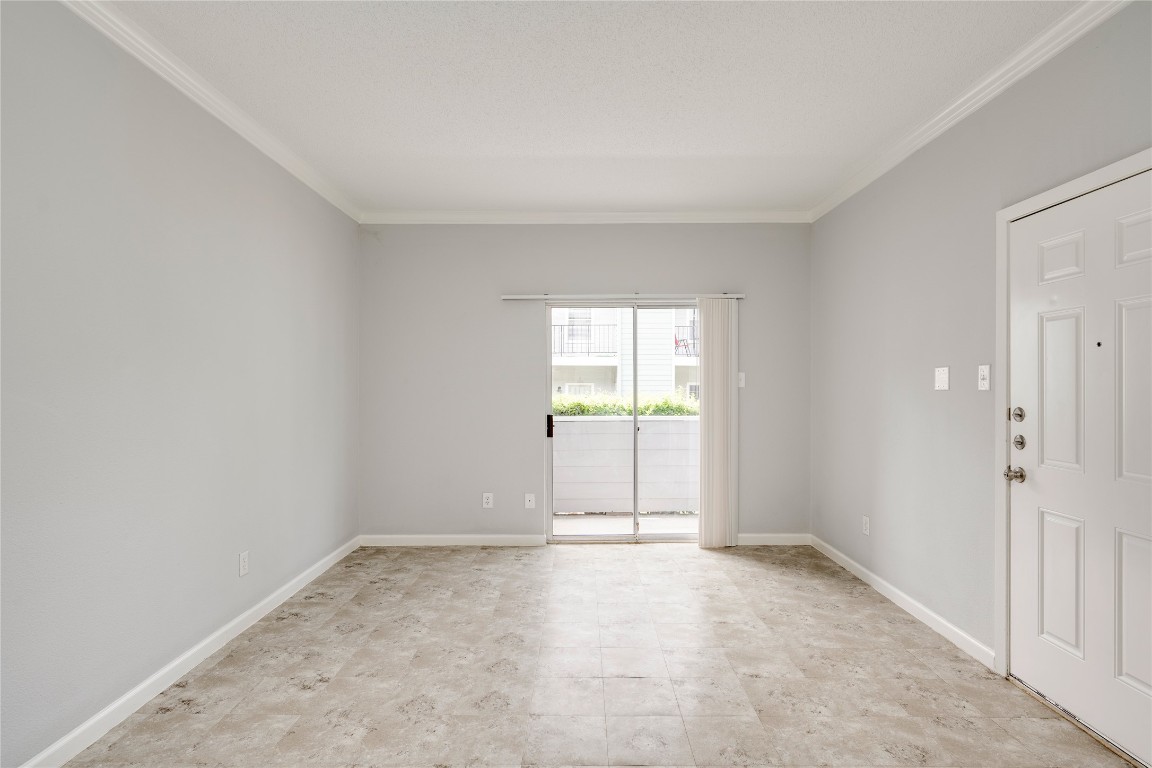 12166 Metric Boulevard, Unit 129 Austin, TX 78758 - Photo 20 of 38 Unfurnished room with ornamental molding and baseboards