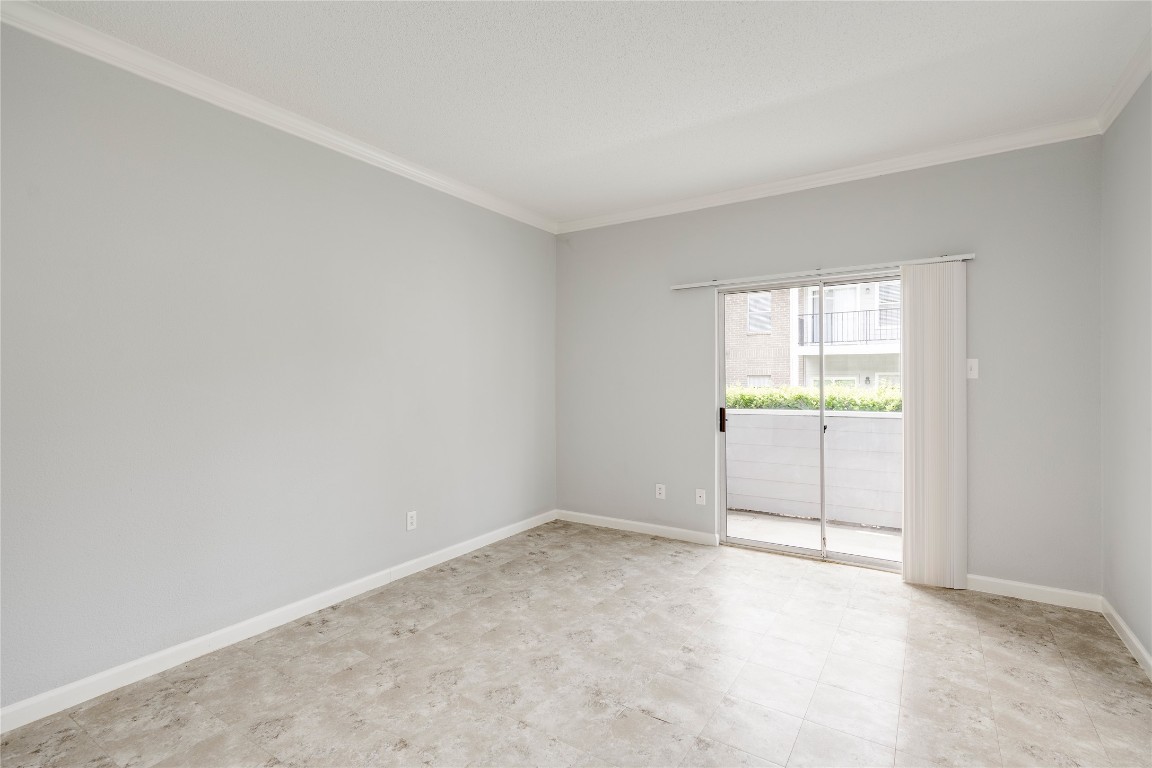 12166 Metric Boulevard, Unit 129 Austin, TX 78758 - Photo 21 of 38 Empty room with ornamental molding