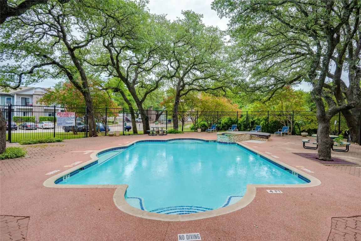 12166 Metric Boulevard, Unit 129 Austin, TX 78758 - Photo 34 of 38 Community pool featuring a patio area