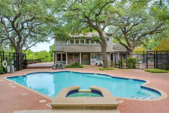 a view of a house with swimming pool and sitting area