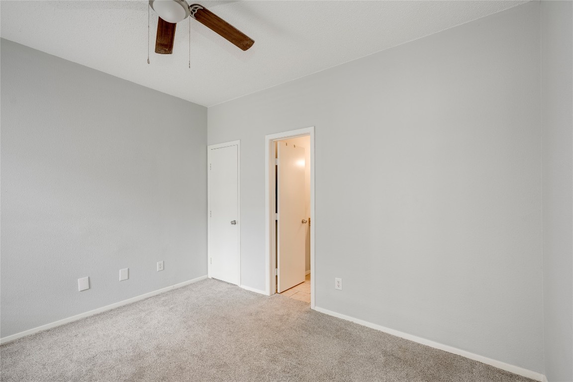 12166 Metric Boulevard, Unit 129 Austin, TX 78758 - Photo 9 of 38 Spare room with ceiling fan and light carpet