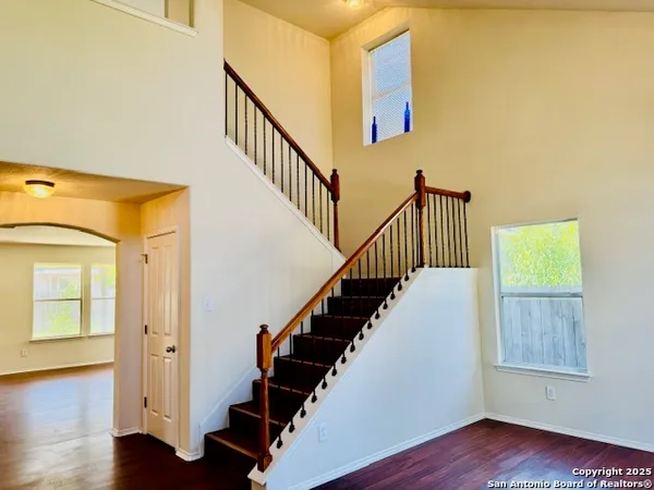 a view of entryway and hall with wooden floor