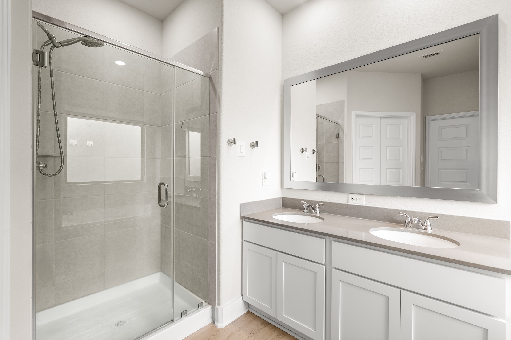 4001 Baja Lane Houston, TX 77045 - Photo 17 of 27 Dual vanities provide dedicated space for the morning routine, while the glass-enclosed shower offers a clean, modern design that enhances both form and function.