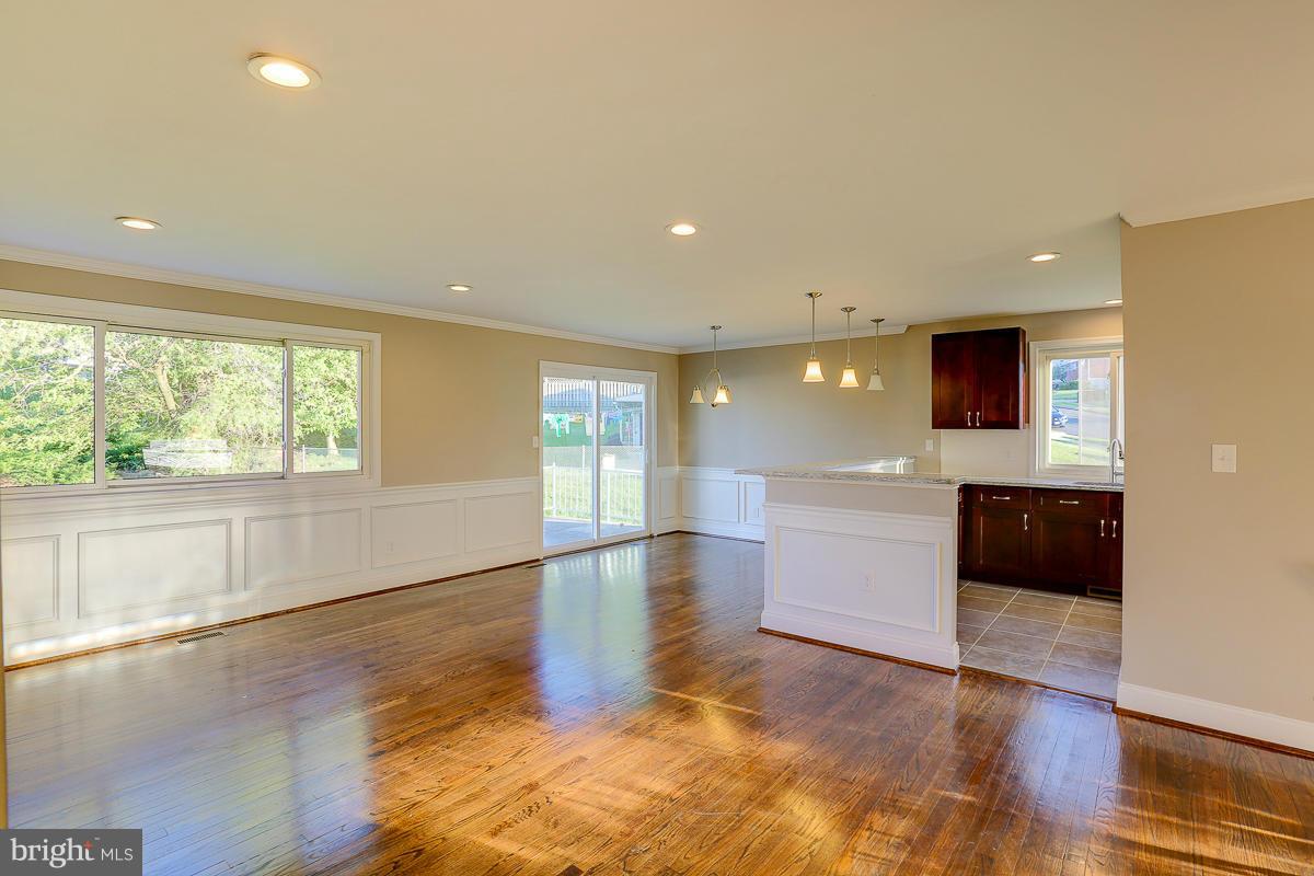 1533 Weyburn Road Baltimore, MD 21237 - Photo 2 of 30 a view of an empty room with a window and wooden floor