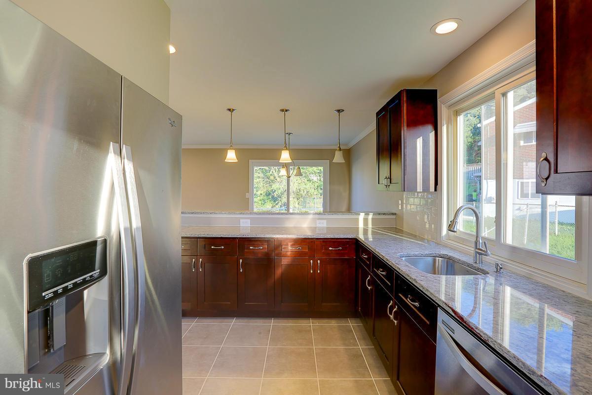 1533 Weyburn Road Baltimore, MD 21237 - Photo 11 of 30 a kitchen with granite countertop a refrigerator and a sink
