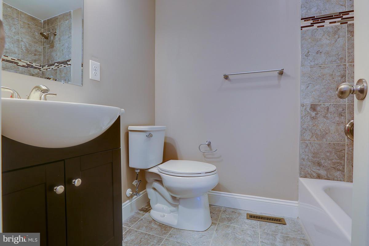 1533 Weyburn Road Baltimore, MD 21237 - Photo 15 of 30 a bathroom with a sink toilet and shower