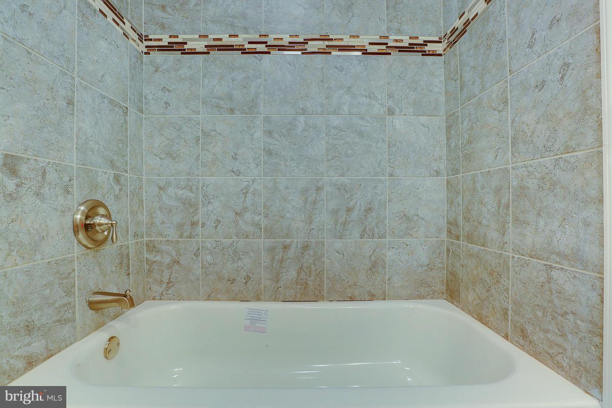 1533 Weyburn Road Baltimore, MD 21237 - Photo 16 of 30 a bath tub sitting next to a shower