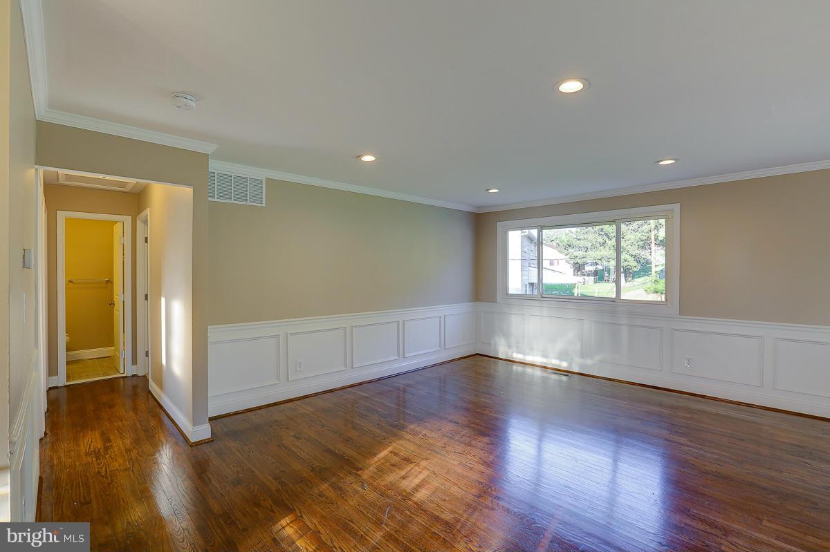 1533 Weyburn Road Baltimore, MD 21237 - Photo 3 of 30 an empty room with wooden floor and windows