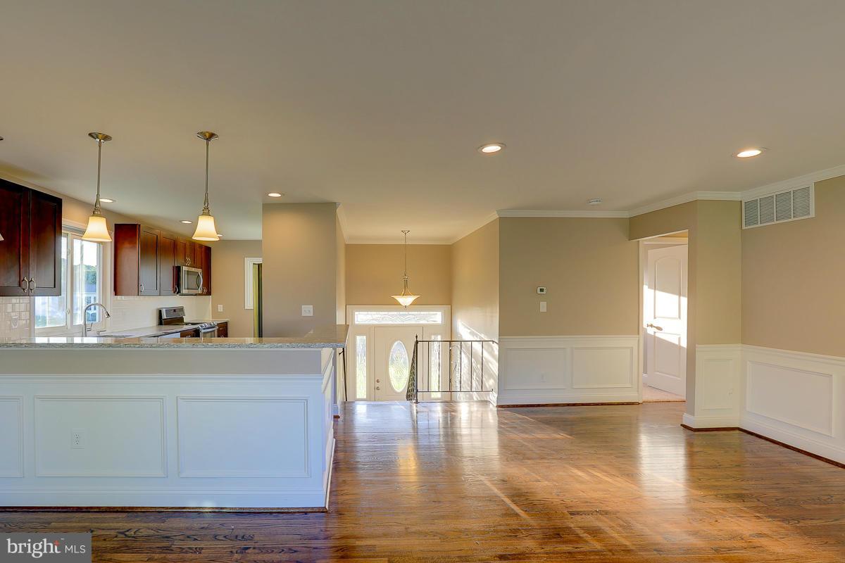 1533 Weyburn Road Baltimore, MD 21237 - Photo 6 of 30 a view of a kitchen with kitchen island a sink stainless steel appliances and cabinets