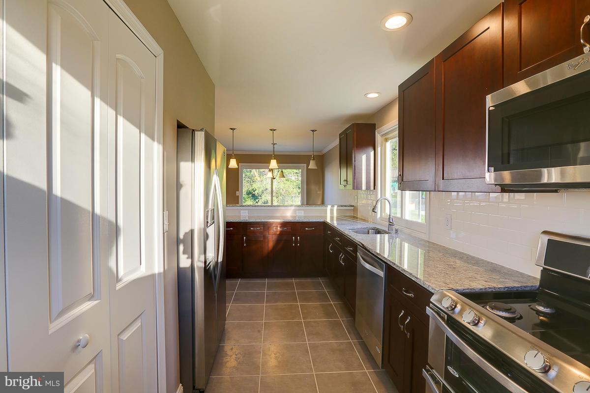 1533 Weyburn Road Baltimore, MD 21237 - Photo 10 of 30 a large kitchen with a large window and stainless steel appliances