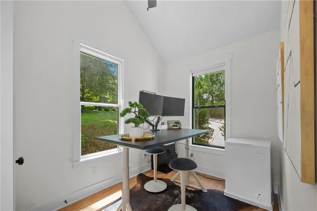 a living room with furniture a dining table and chairs