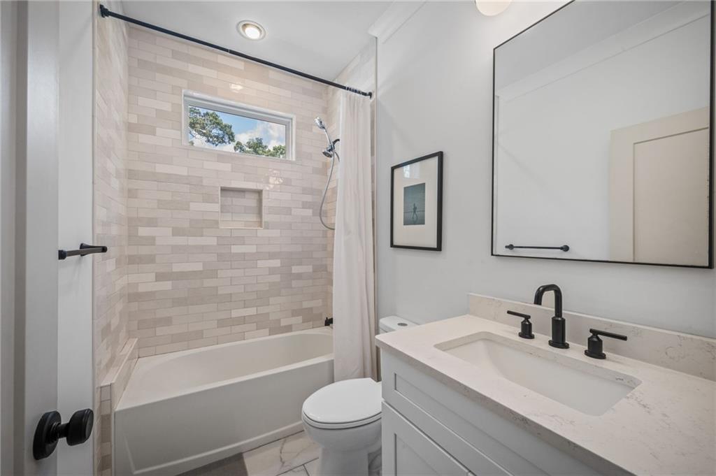 1058 Sanders Avenue Southeast Atlanta, GA 30316 - Photo 19 of 55 a bathroom with a sink toilet and shower