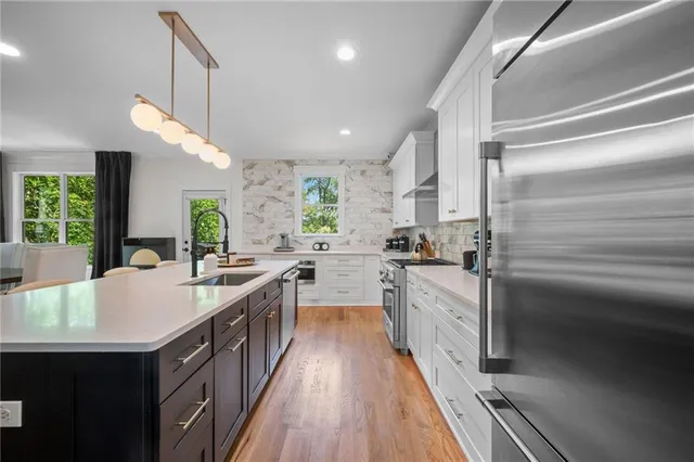 a kitchen with kitchen island granite countertop lots of counter top space and stainless steel appliances