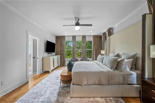 a bed room with couch and a window