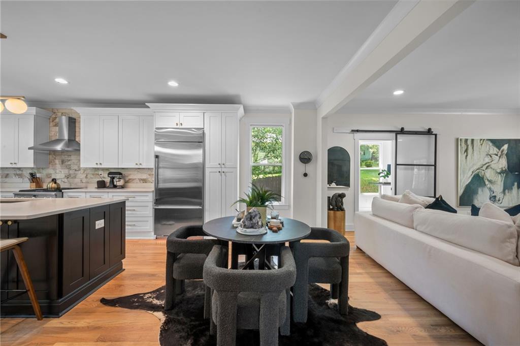 1058 Sanders Avenue Southeast Atlanta, GA 30316 - Photo 34 of 55 a living room with stainless steel appliances kitchen island granite countertop furniture and a wooden floor