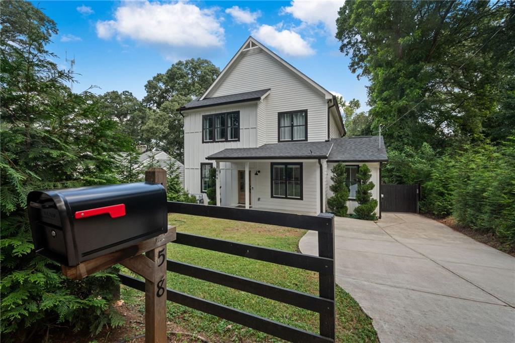 1058 Sanders Avenue Southeast Atlanta, GA 30316 - Photo 41 of 55 a view of a white house with a yard and a bench