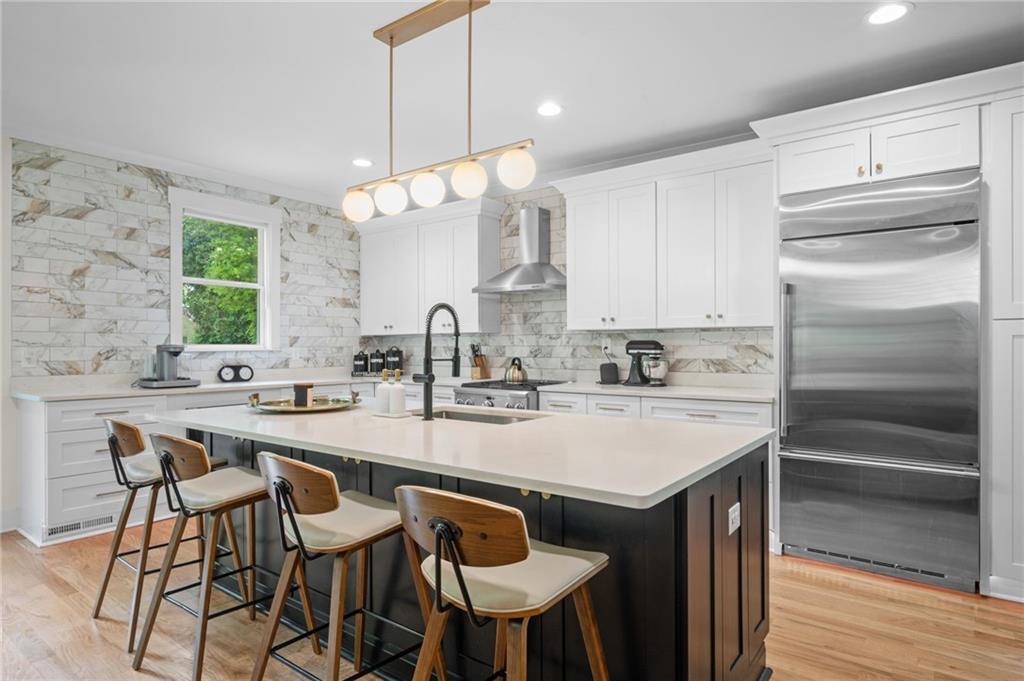 1058 Sanders Avenue Southeast Atlanta, GA 30316 - Photo 48 of 55 a kitchen with kitchen island a sink stove and refrigerator