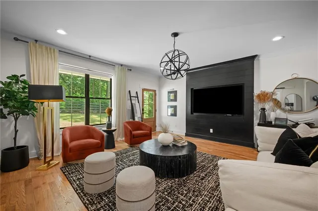 a spacious bedroom with a bed a couch and a large window