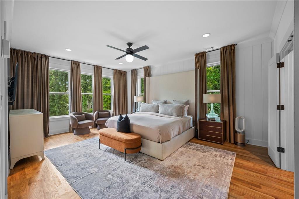 1058 Sanders Avenue Southeast Atlanta, GA 30316 - Photo 6 of 55 a spacious bedroom with a bed a couch and a large window