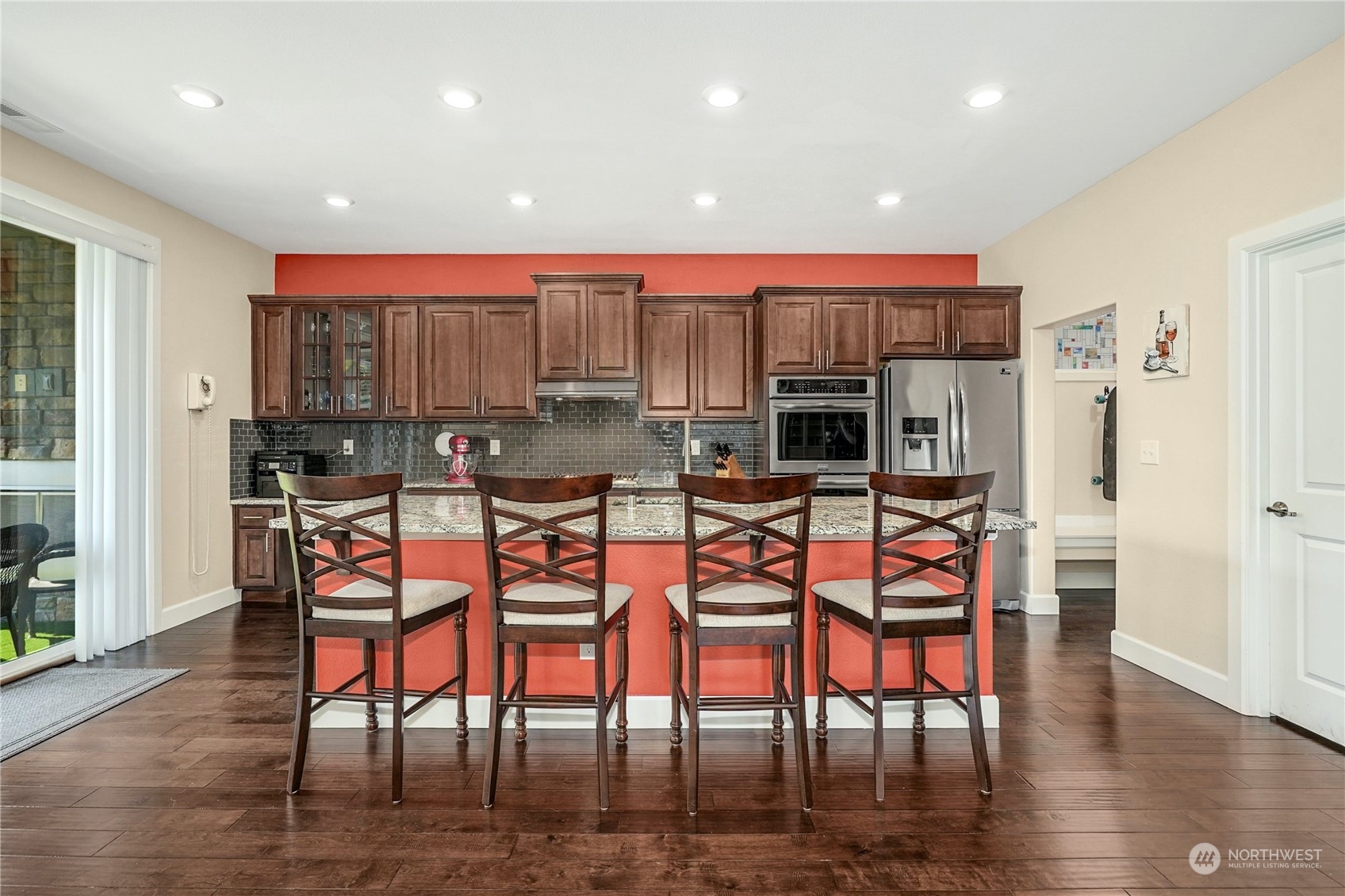 4012 174th Street Southeast Bothell, WA 98012 - Photo 11 of 36 a kitchen with stainless steel appliances a dining table chairs and a refrigerator
