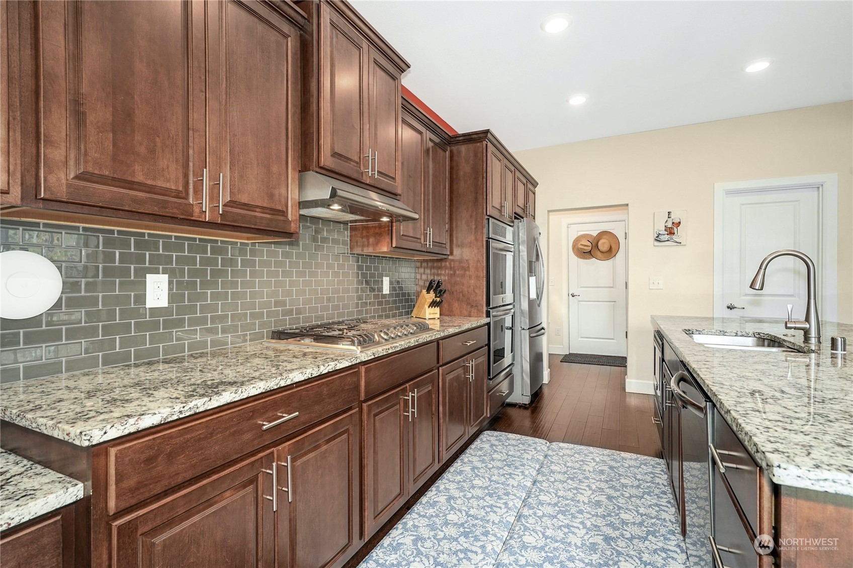 4012 174th Street Southeast Bothell, WA 98012 - Photo 14 of 36 a kitchen with stainless steel appliances granite countertop a sink stove and cabinets