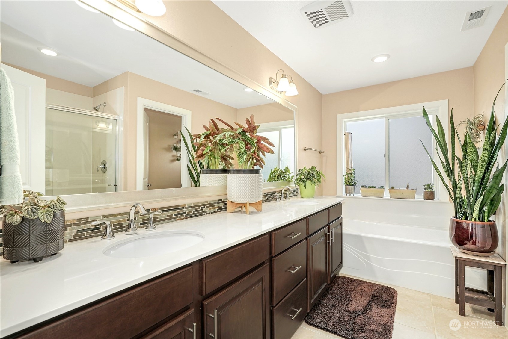 4012 174th Street Southeast Bothell, WA 98012 - Photo 19 of 36 a bathroom with a sink a large mirror and a bathtub