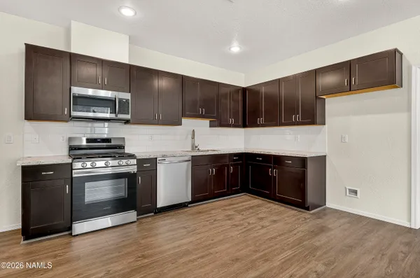 a kitchen with a refrigerator stove and microwave