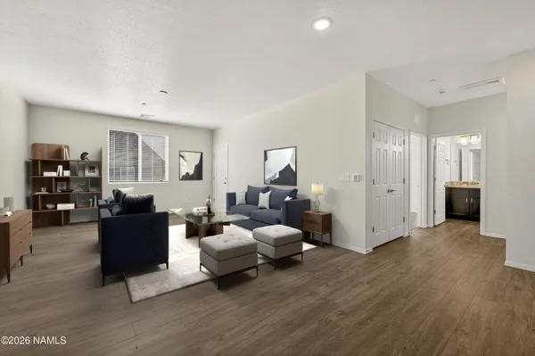 a living room with furniture and wooden floor