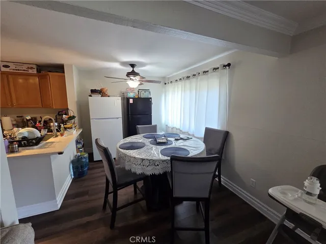 a view of a dining room with furniture and kitchen view